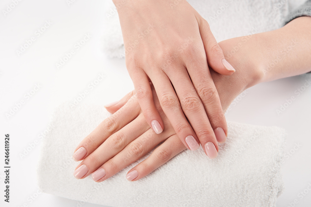 Partial view of woman applying cosmetic cream on white background Partial view of woman applying cosmetic cream on white background