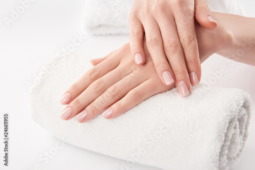 Fototapeta Naklejka Na Ścianę i Meble -  Partial view of female hands on terry towel on white background