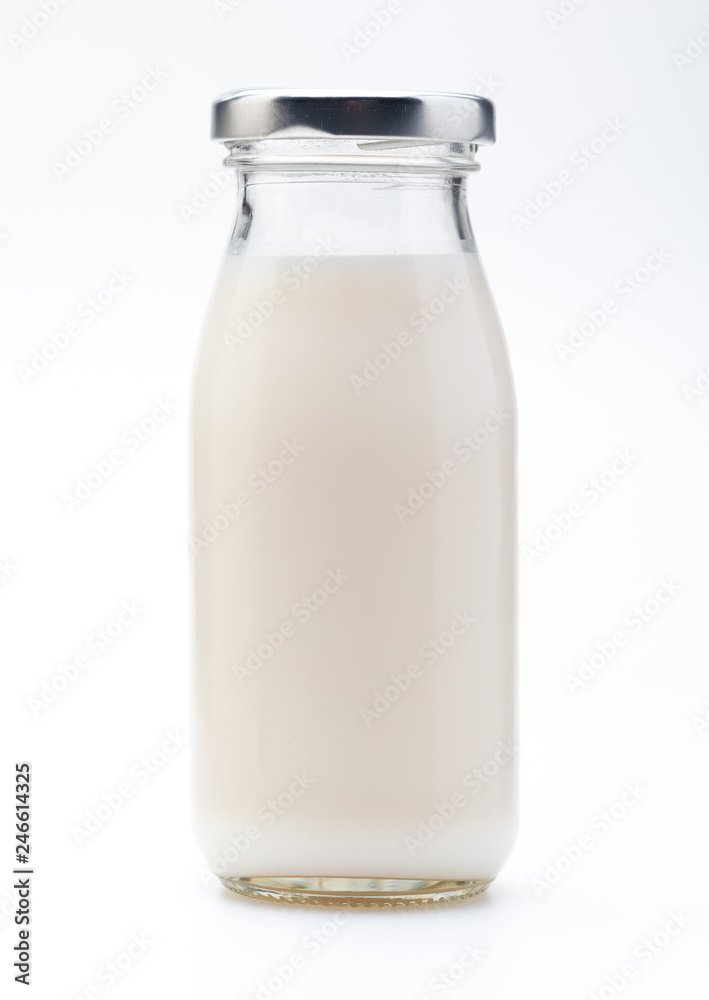 Milk in glass bottle. With cap. Isolated on white background. Milk in glass bottle. With cap. Isolated on white background.