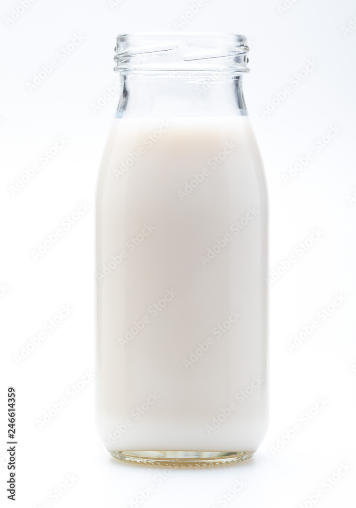 Milk in glass bottle. Without lid. Isolated on white background. Milk in glass bottle. Without lid. Isolated on white background.