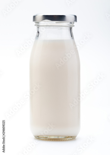 Milk in glass bottle. With cap. Isolated on white background.