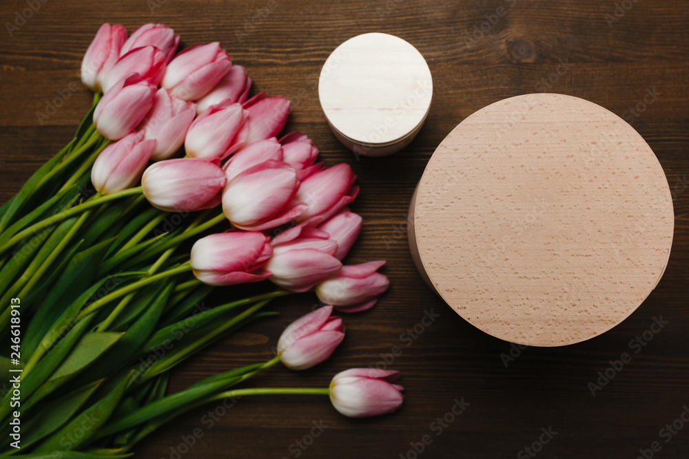 Pink tulips and candle on the wooden background Pink tulips and candle on the wooden background