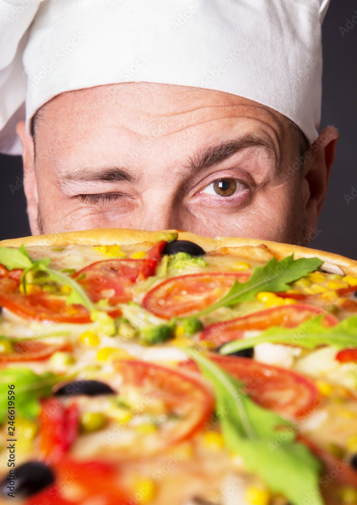 Portrait of happy attractive cook with a pizza Portrait of happy attractive cook with a pizza