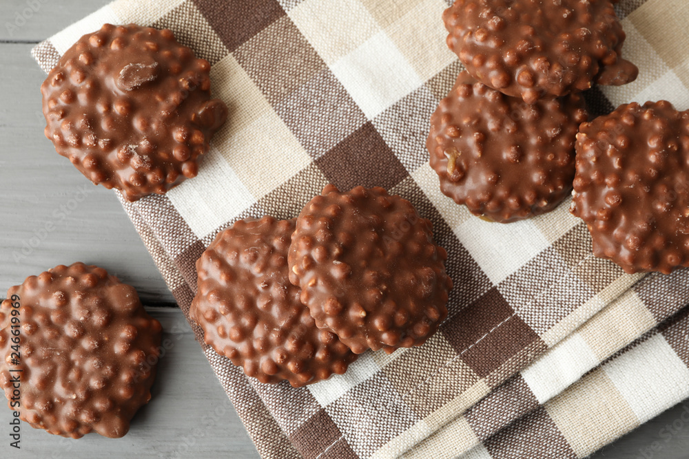 Tasty chocolate cookies on napkin and wooden background, top view Tasty chocolate cookies on napkin and wooden background, top view
