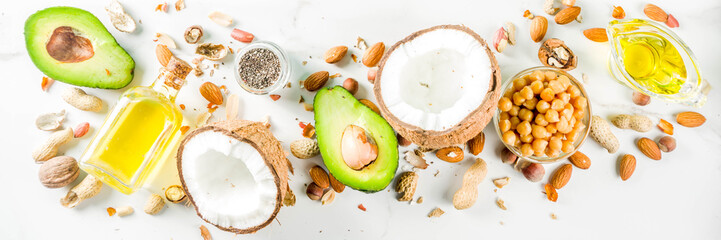 Healthy vegan fat food sources, omega3, omega6 ingredients - almond, pecan, hazelnuts, walnuts, olive oil, chia seeds, avocado, coconut,  banner copy space