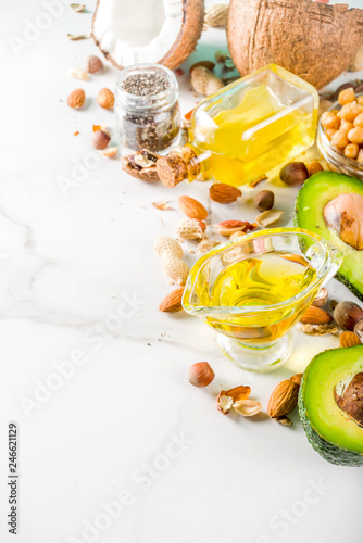 Healthy vegan fat food sources  omega3  omega6 ingredients - almond  pecan  hazelnuts  walnuts  olive oil  chia seeds  avocado  coconut   banner copy space