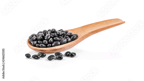 Black beans in wooden spoon on white background.