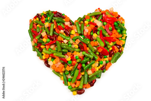 Heart made of vegetables. Corn, carrot, bell pepper, green beans. Isolated on white.