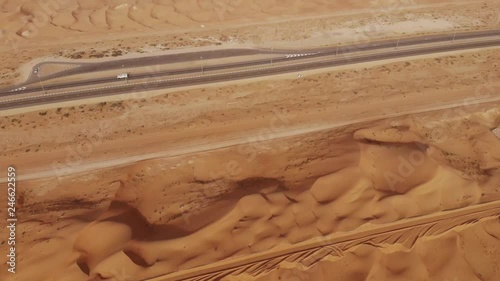 AERIAL. Dubai desert roads being covered in sand from the desert