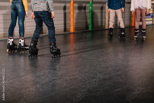 Partial view of preteen roller skaters practicing together