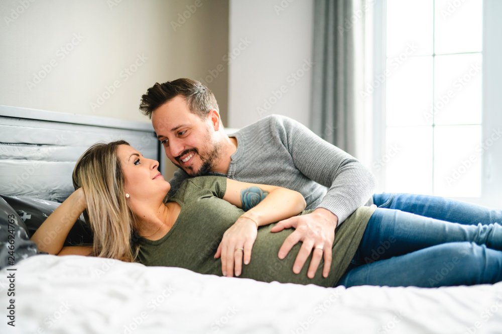 The parents in bed expecting a little baby, Romantic moments for pregnant couple The parents in bed expecting a little baby, Romantic moments for pregnant couple