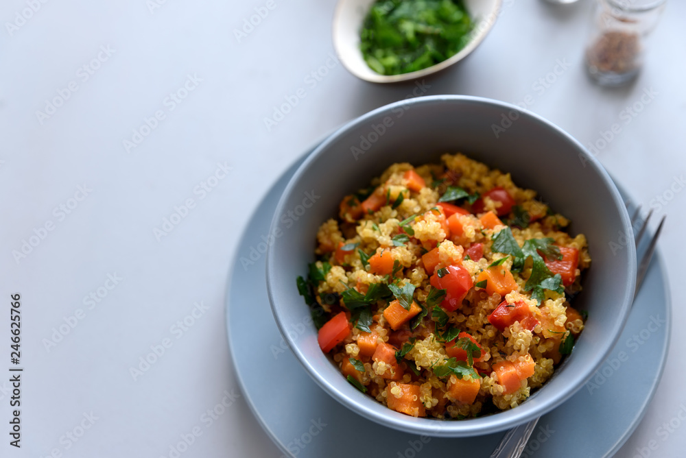 Healthy vegan bowl with quinoa, pumpkin, pepper and carrot on gray wooden background. Selective focus Healthy vegan bowl with quinoa, pumpkin, pepper and carrot on gray wooden background. Selective focus