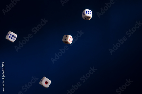 Flying dice on blue background.