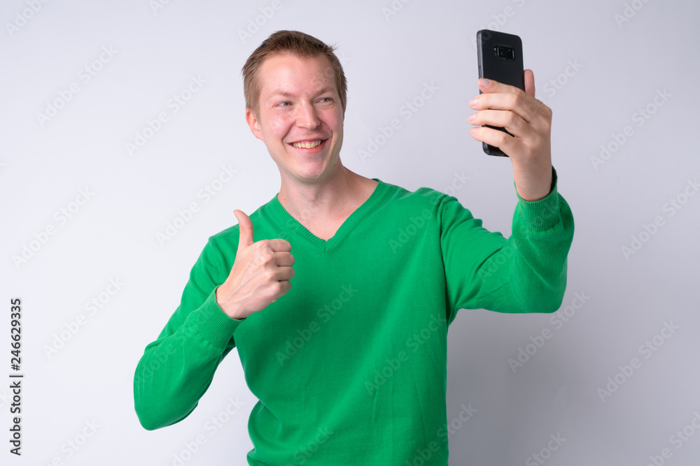 Happy young handsome man taking selfie phone Happy young handsome man taking selfie phone