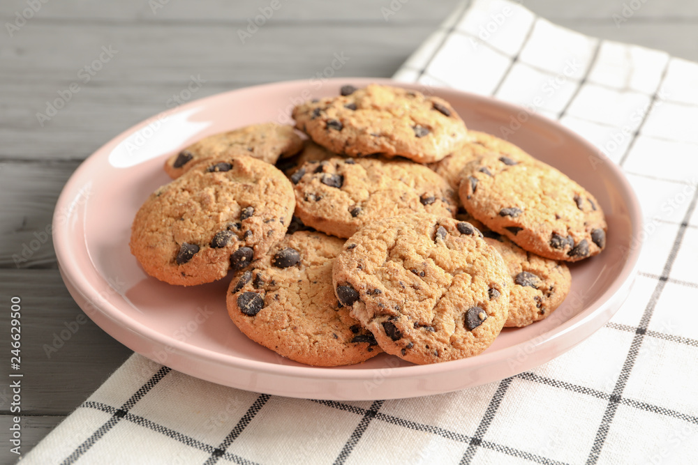 Plate with chocolate chip cookies and space for text on wooden table Plate with chocolate chip cookies and space for text on wooden table