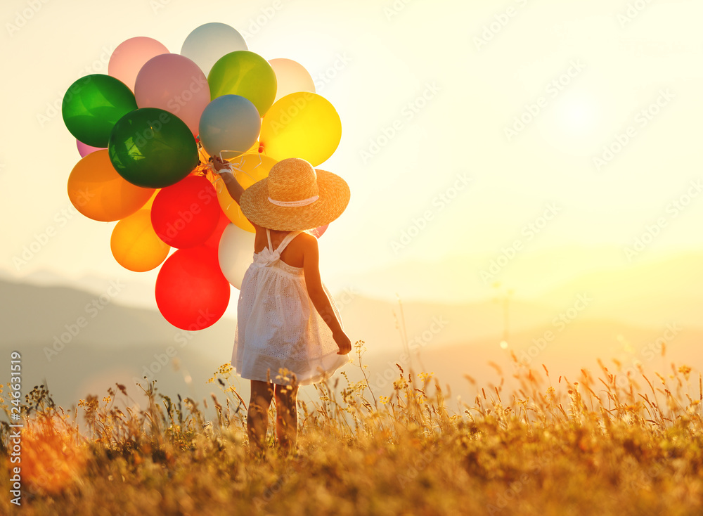 . happy child with balloons at sunset in summer - obrazy, fototapety, plakaty 