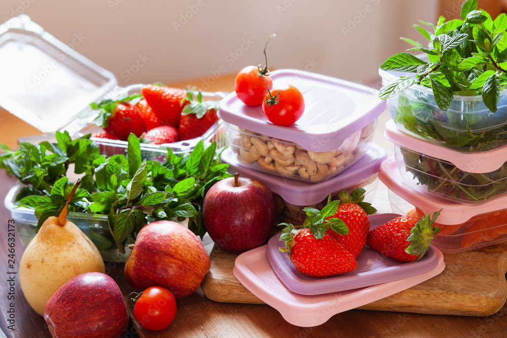 Filled plastic containers to save food, herbs and fruits fresh, concept of economy household