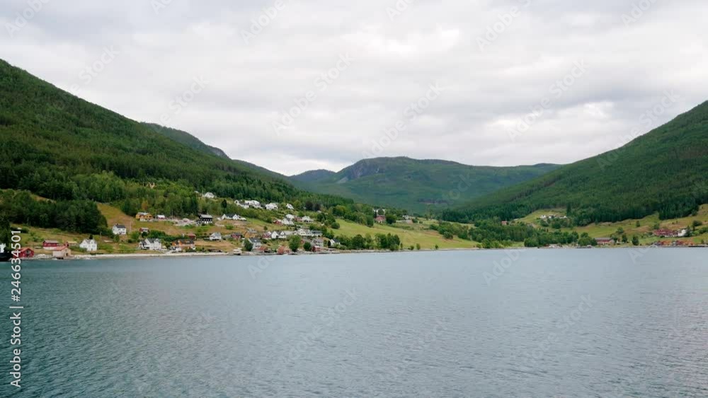 Sail On The Beautiful Bay Of Norwegian Fjords Against The Hills With The Village Sail On The Beautiful Bay Of Norwegian Fjords Against The Hills With The Village