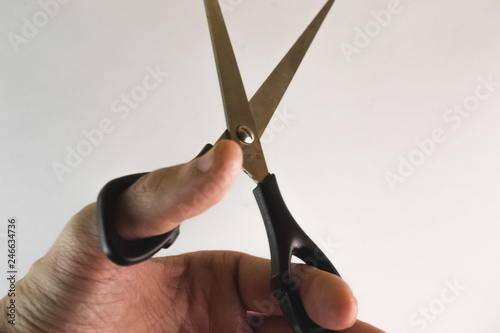 scissors in hand isolated on white closeup