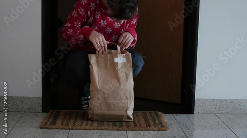 taking bag with box diet from under the door photo