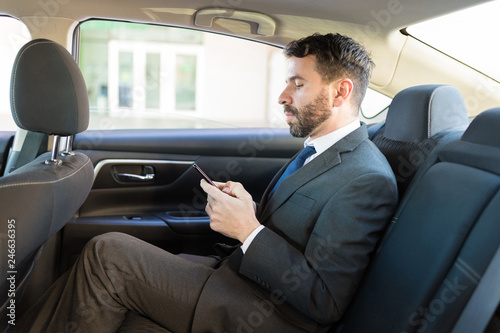 Manager Using Online Application Via Smartphone In Car © AntonioDiaz