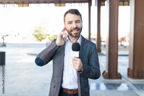 Attractive Correspondent Taking Interview Outdoors photo