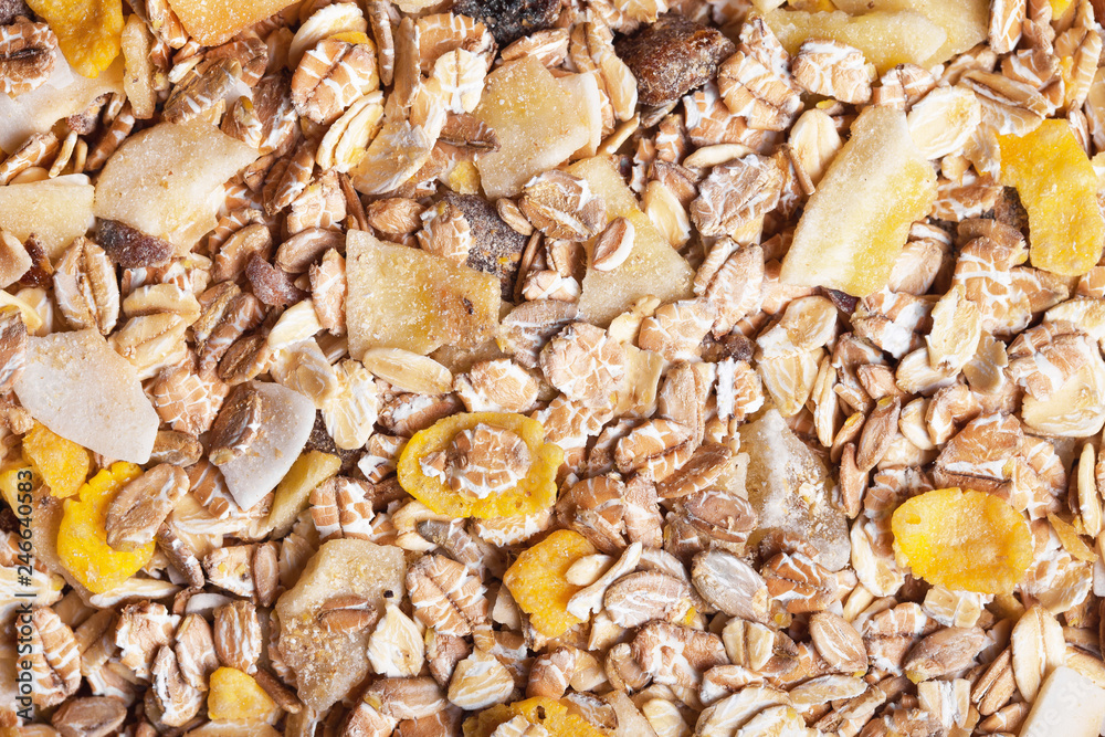 Healthy fat reduction diet studio background. Breakfast oat flakes with mix of dry fruits closeup pattern. 