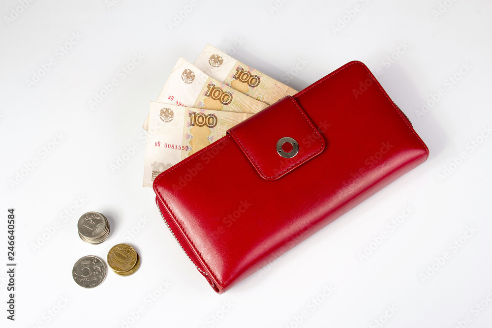 Banknotes in a red wallet and coins on a white background Banknotes in a red wallet and coins on a white background