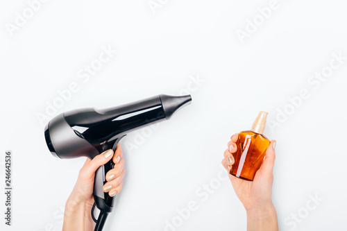 Top view woman's hands holding hair dryer