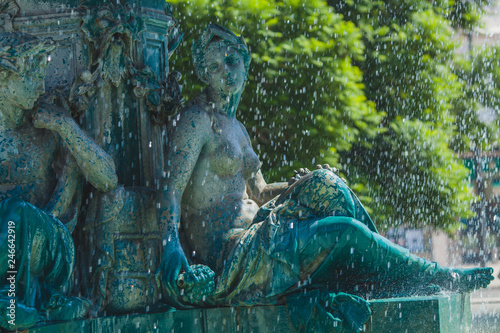 a fountain with sirens on the square of Rossio in Lisbon