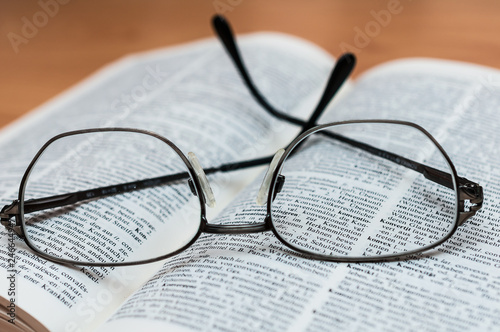 Closeup of Reading Glasses on Book