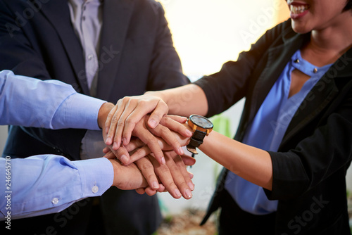 Cropped image of business team stacking hands to express unity and improve communication
