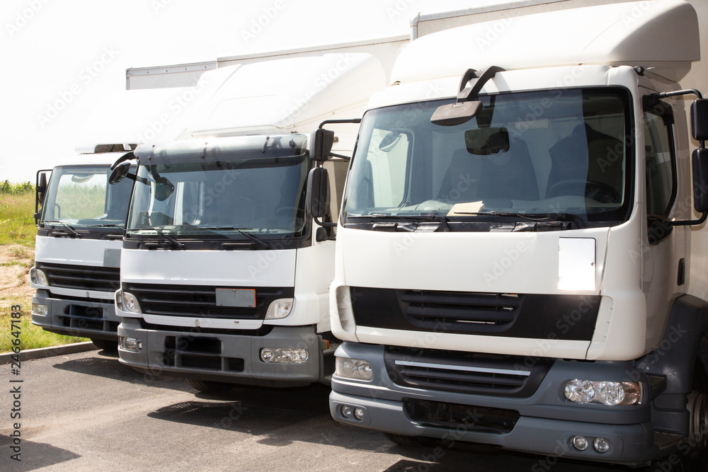 three face truck white for delivery front of warehouse