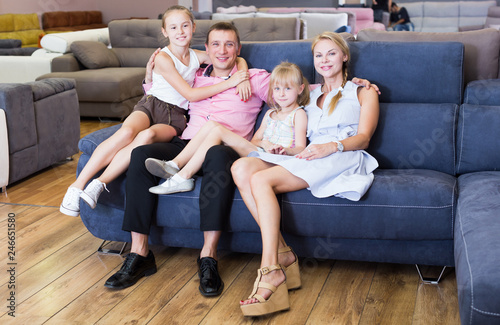 Family is pleased by new sofa in store.