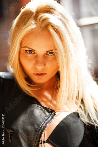 Beautiful and cute blonf girl posing for photo in the loft studio