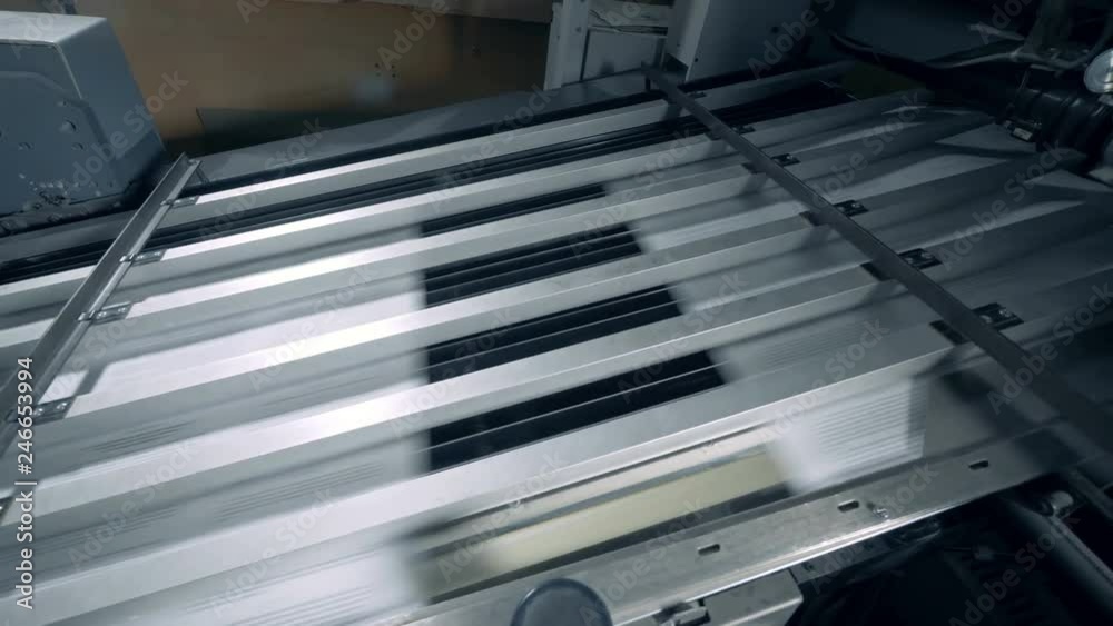 Pieces of paper are moving fast through the printing press Pieces of paper are moving fast through the printing press