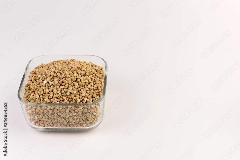 Natural fresh green buckwheat in g lass bowl isolated on white background. Natural fresh green buckwheat in g lass bowl isolated on white background.