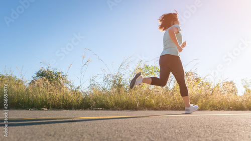 Low Section Of Woman Running On Road