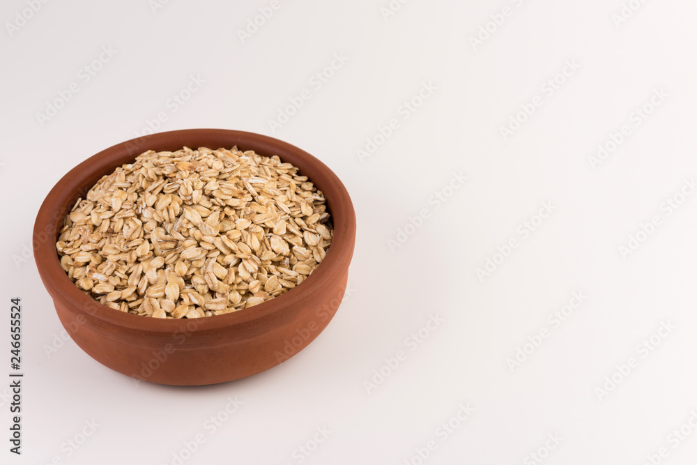 Dry rolled oatmeal in bowl isolated on white background. Dry rolled oatmeal in bowl isolated on white background.
