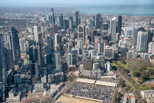 MELBOURNE - SEPTEMBER 8, 2018: Aerial view of city skyline and car parking from helicopter. Melbourne attracts 15 million people annually