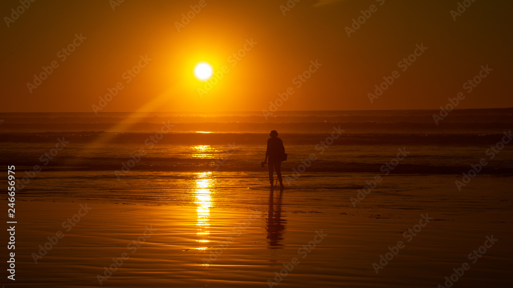 Morocco Agadir December 10th 2018 - Main Agadir Beach sunset and silhouette of people in wave