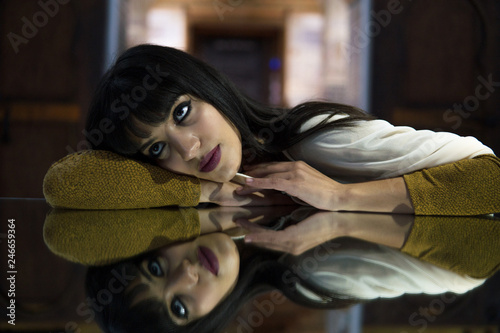 Beautiful Moroccan Girl in Short Golden Dress in Rich Mosaic interior of Picturesque Dar Si Said Riyad in Marrakech photo