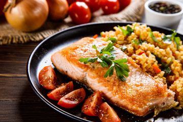 Roast salmon with groats and vegetables