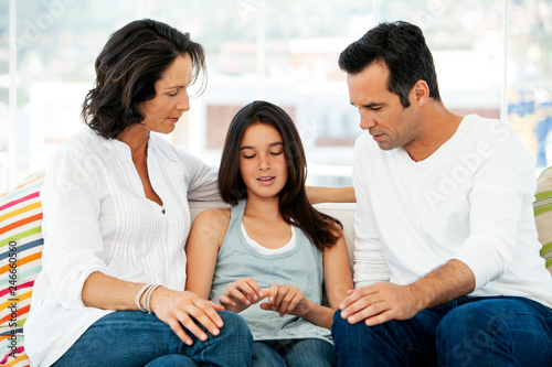 Parents having educative discussion with teenage girl