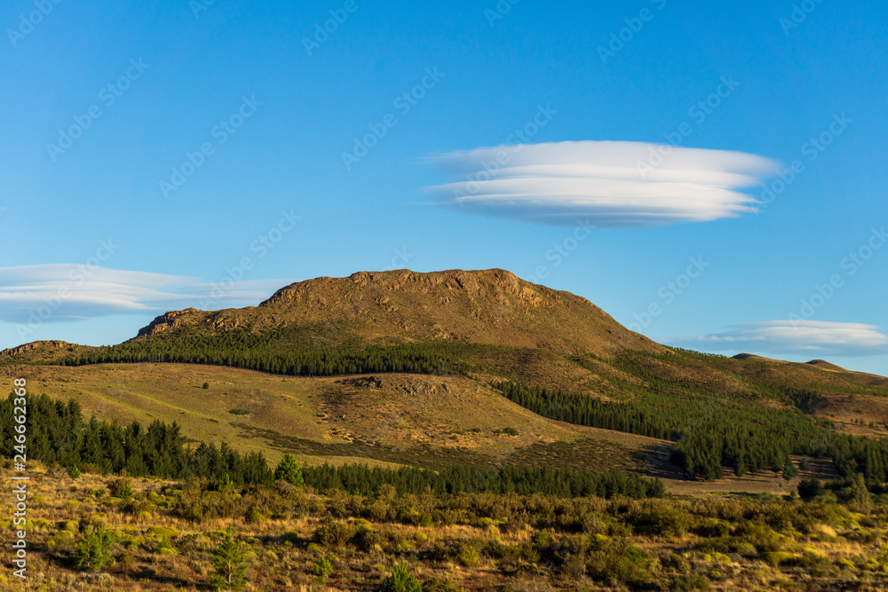 Andes mountain range against lenticular clouds in the sky Andes mountain range against lenticular clouds in the sky