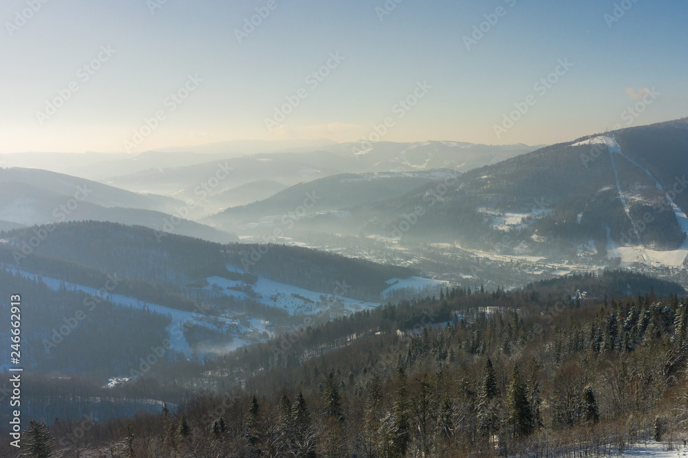 Obraz premium Winter scenery in Silesian Beskids mountains. View from Rownica, Ustron. View from above. Landscape photo captured with drone. Poland, Europe.