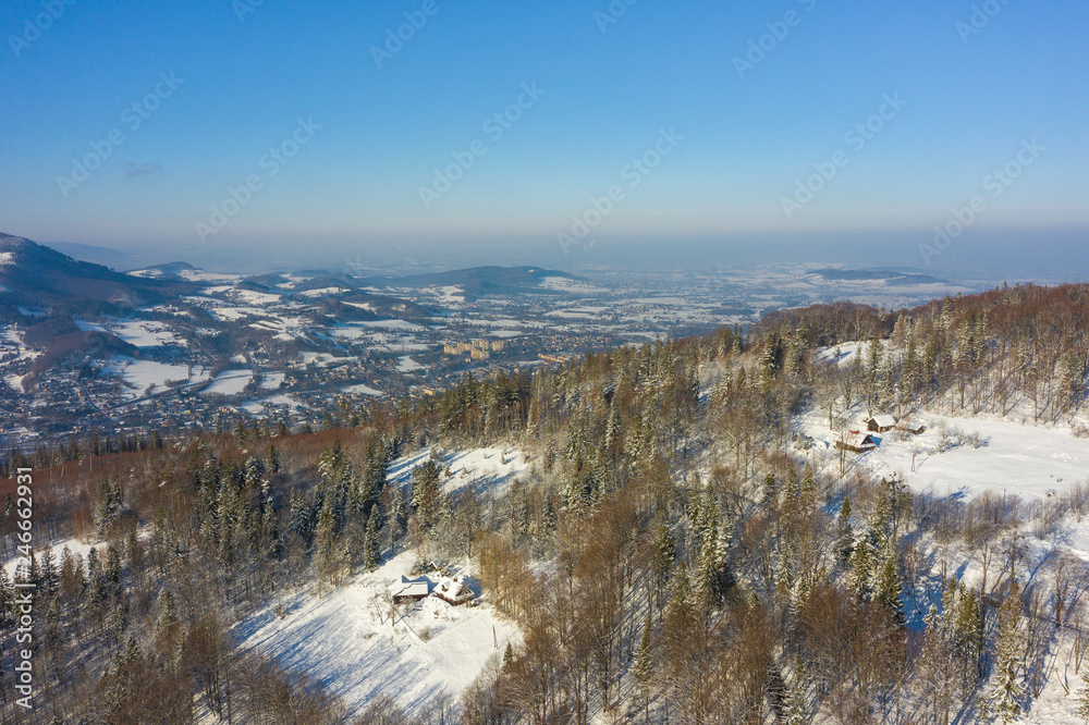 Winter scenery in Silesian Beskids mountains. View from Rownica, Ustron. View from above. Landscape photo captured with drone. Poland, Europe.