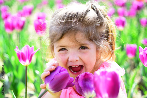 Summer girl fashion. Happy childhood. Springtime tulips. weather forecast. Small child. Natural beauty. Childrens day. Little girl in sunny spring. face and skincare. allergy to flowers. so happy