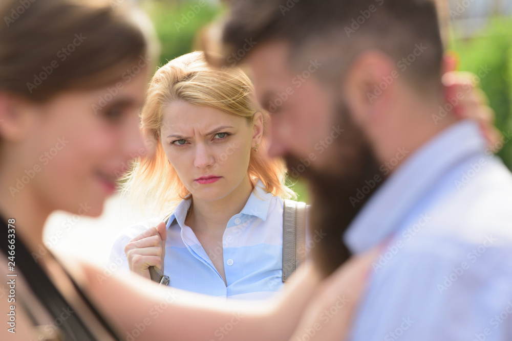 She is obviously jealous. Bearded man cheating his girlfriend with another  woman. Unhappy girl feeling jealous.