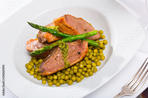 Duck breast with green pea and asparagus photo